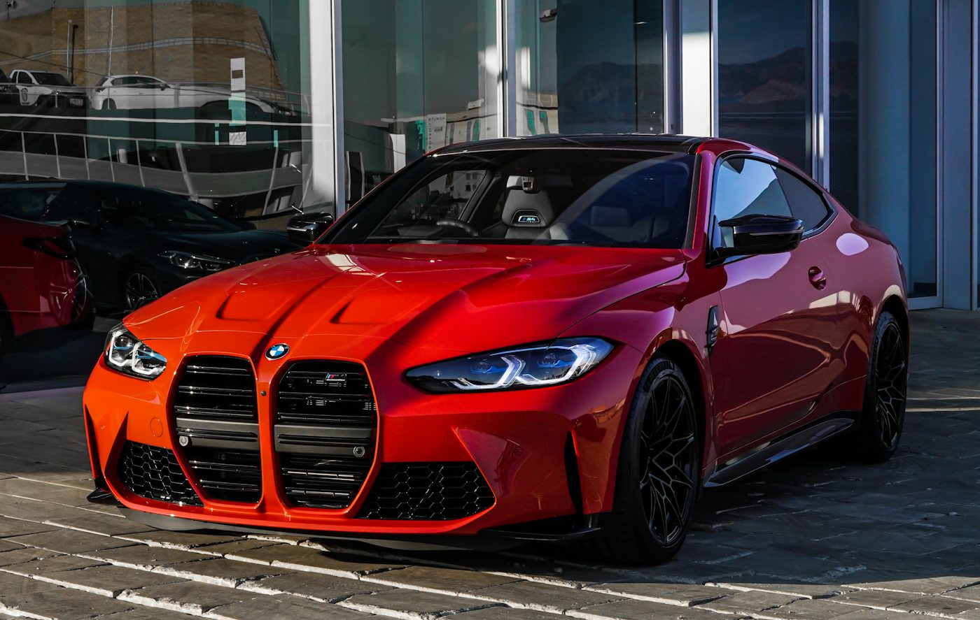 New car in front of a dealership showroom